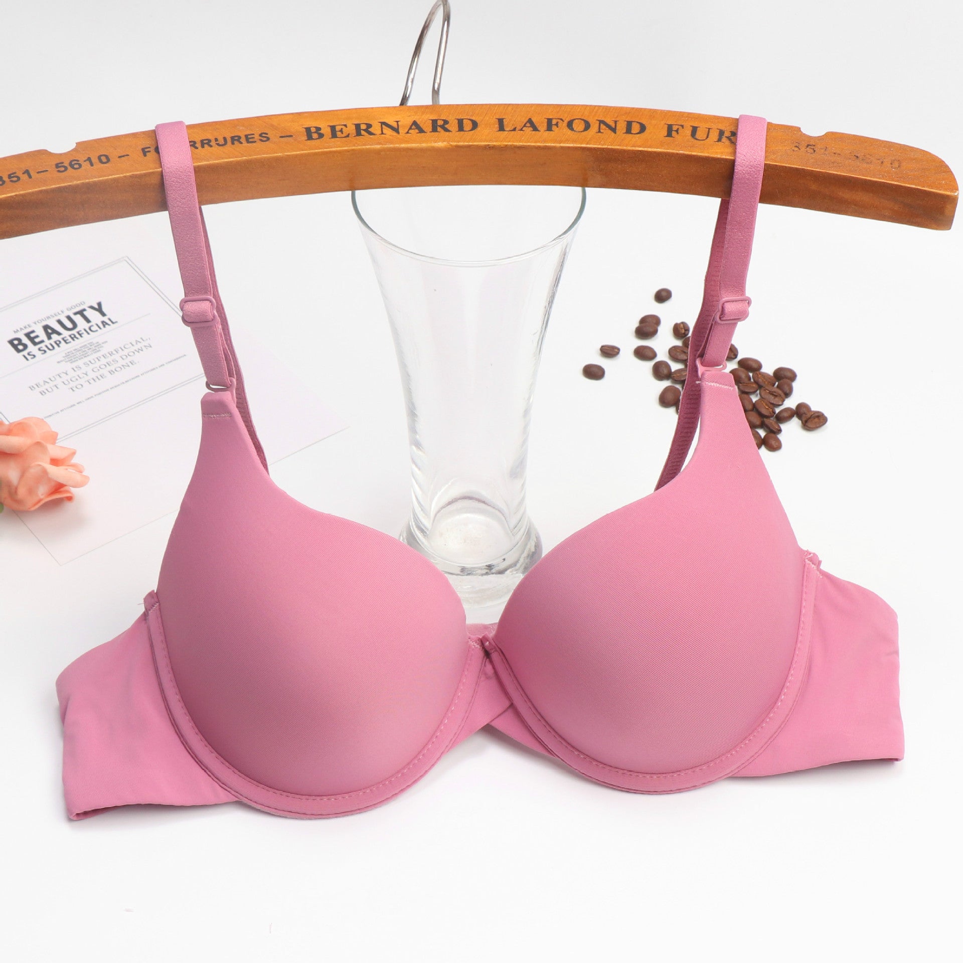Pink bra on a wooden hanger with a blurred background