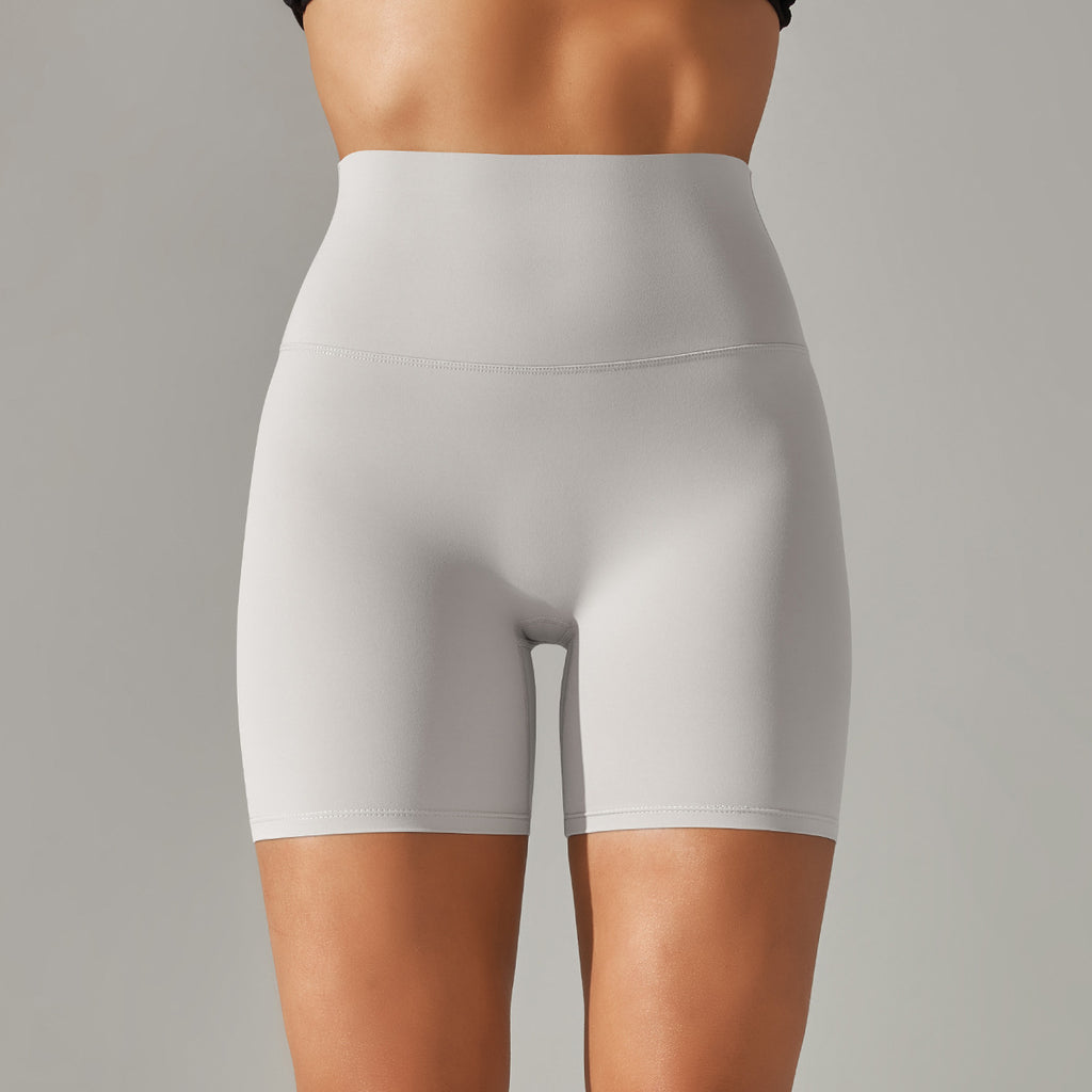 Light gray high-waisted shorts worn by a person on a gray background