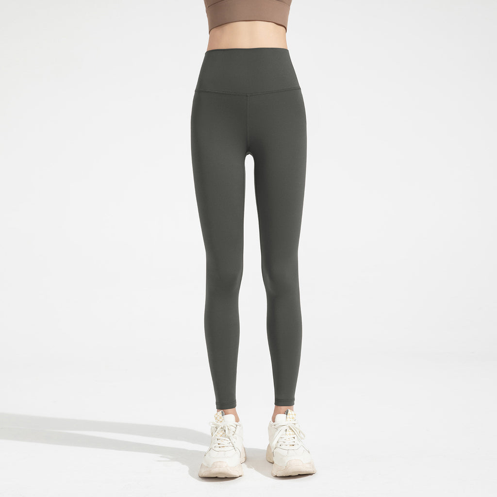 Person wearing dark gray leggings on a white background