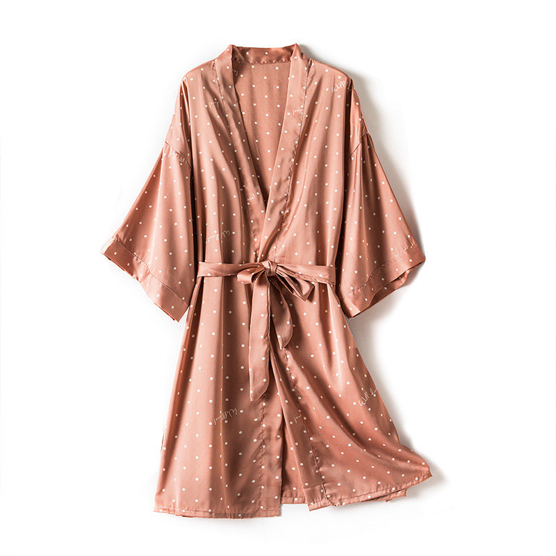 Pink polka dot robe on a white background