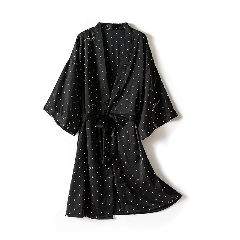 Black dress with white polka dots on a white background