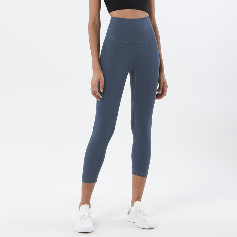Person wearing blue leggings on a white background