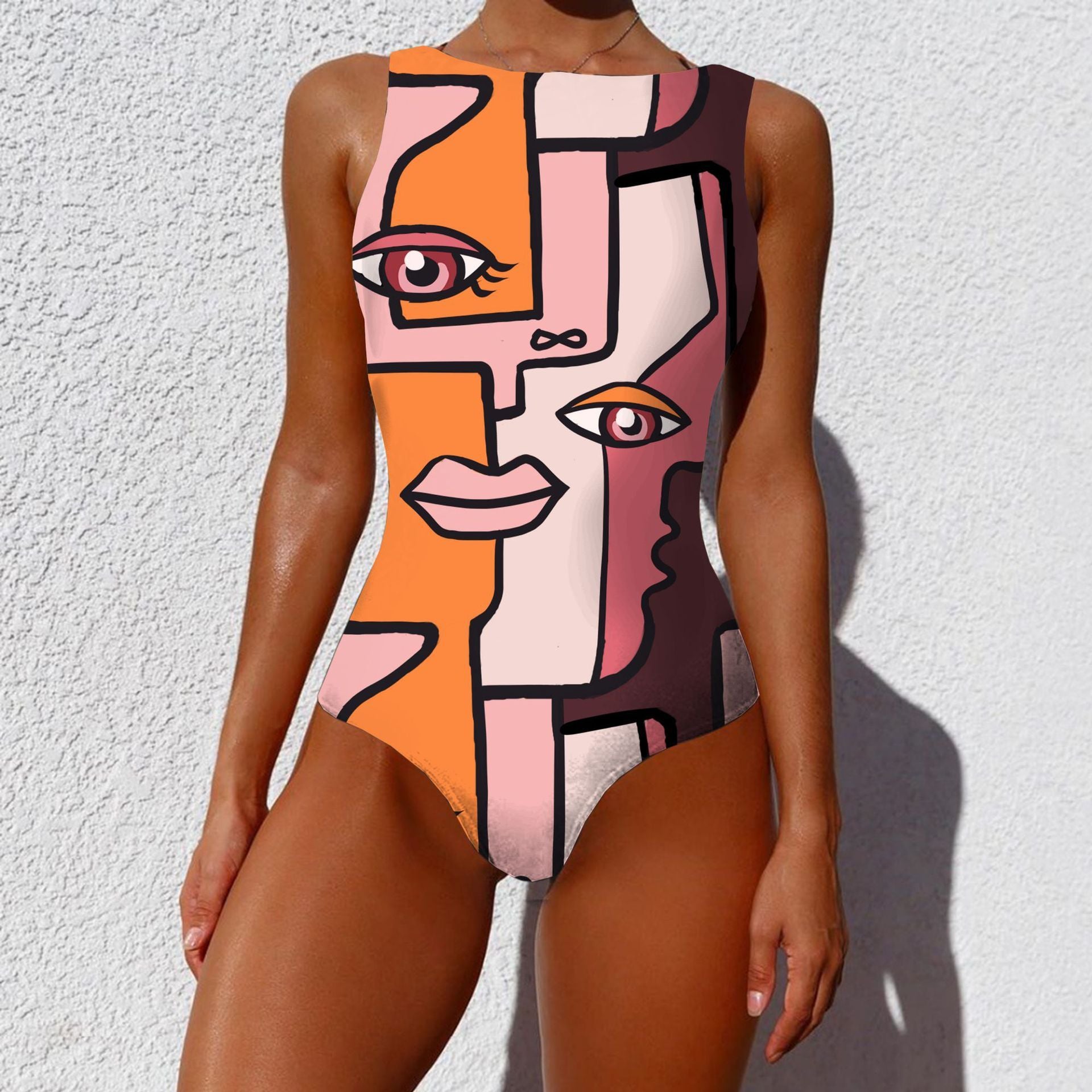 Person wearing a colorful abstract art swimsuit against a white wall