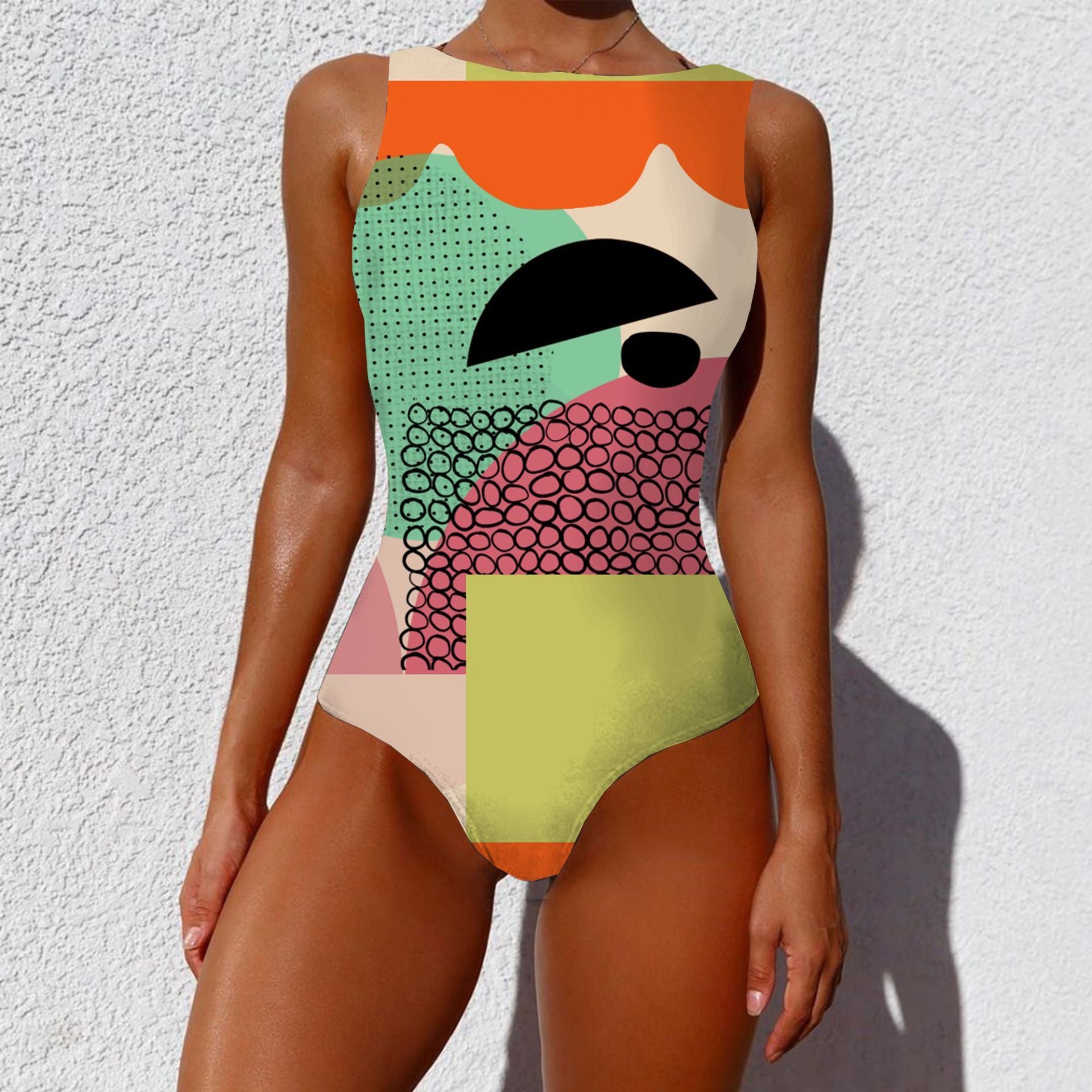 Colorful geometric-patterned swimsuit against a white background