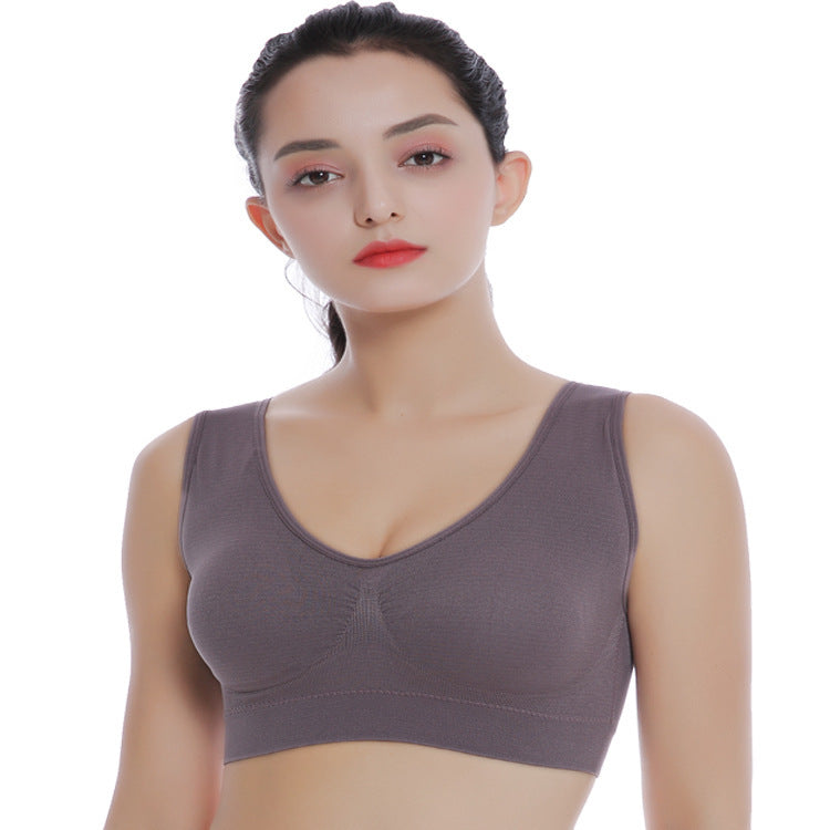 Woman wearing a gray bra on a white background