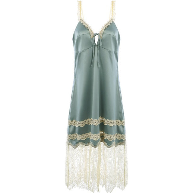 Green slip dress with lace details on a white background