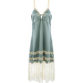Green slip dress with lace details on a white background