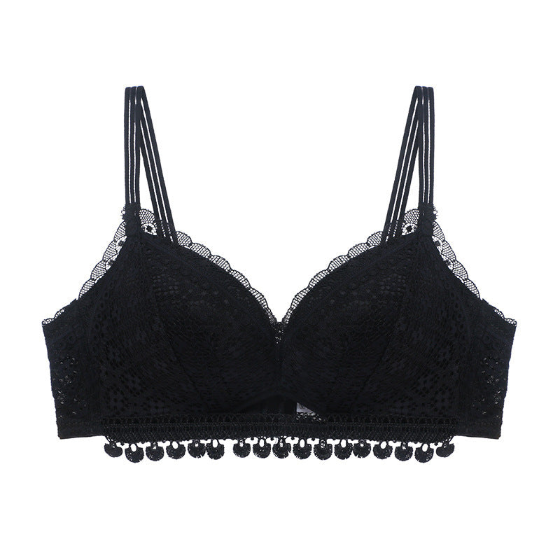 Black bra with lace details and decorative elements on a white background