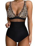 Leopard print bikini top and black high-waisted bottoms on a white background
