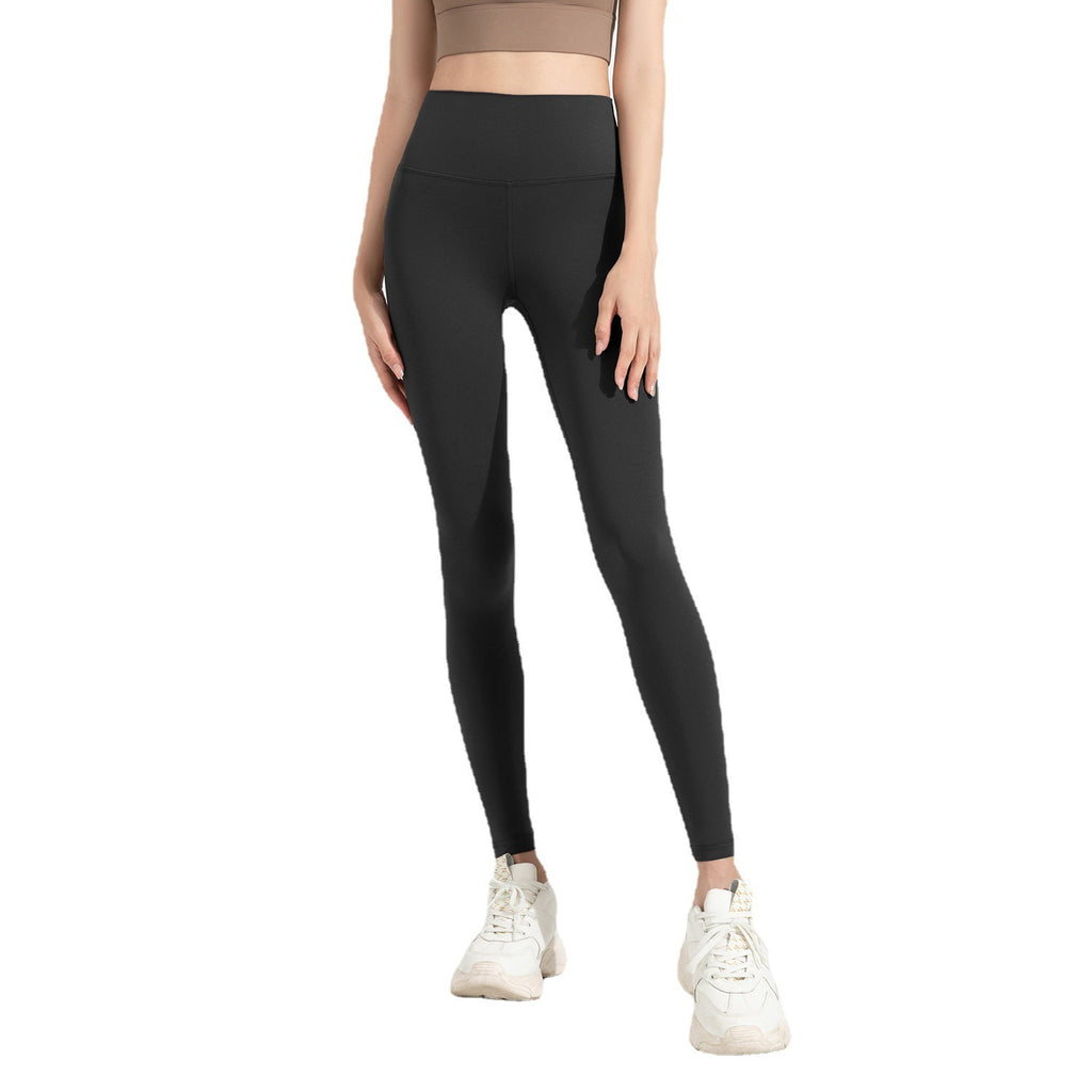 Person wearing black leggings on a white background