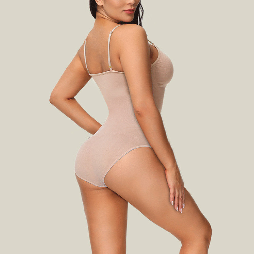 Woman wearing a beige bodysuit against a plain background