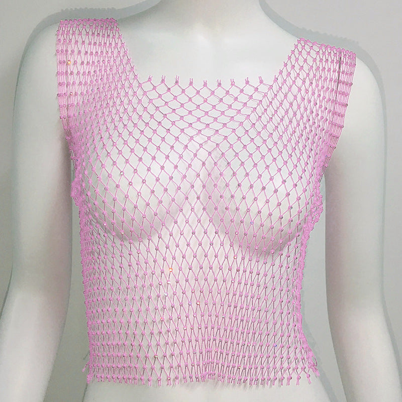 Pink fishnet top on a mannequin against a gray background