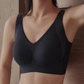 Black sports bra worn by a person against a neutral background