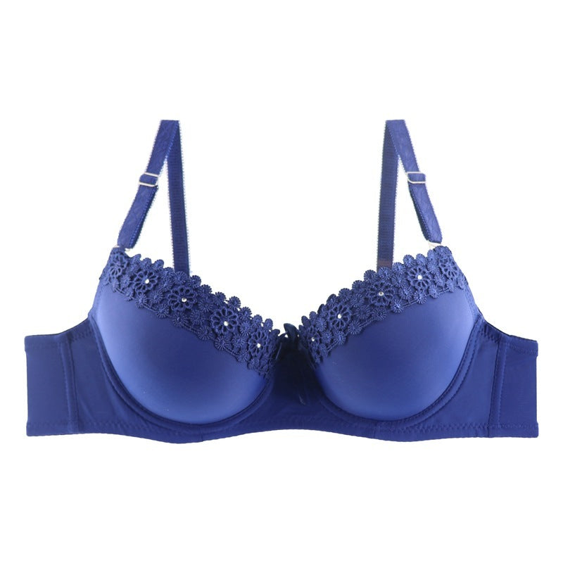 Blue bra with lace detailing on a white background