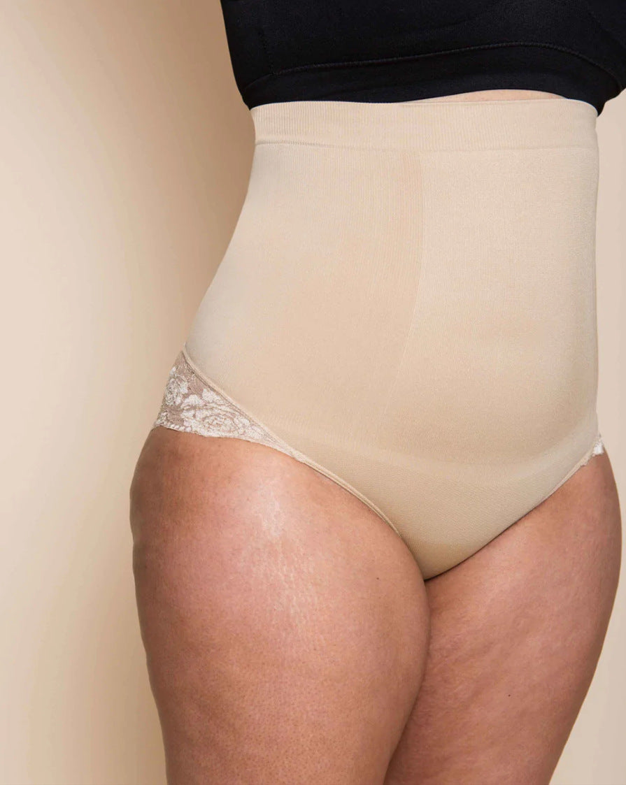 Beige underwear with lace trim worn by a person on a beige background