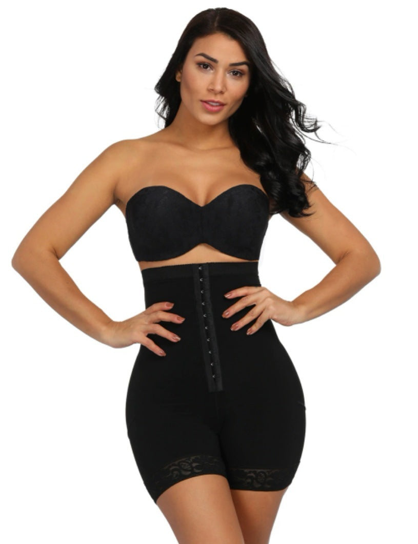 Woman wearing a black waist trainer on a white background