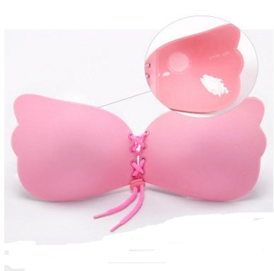 Pink butterfly-shaped product with a clear dome on a white background