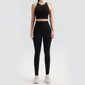 Person wearing a black athletic outfit on a white background