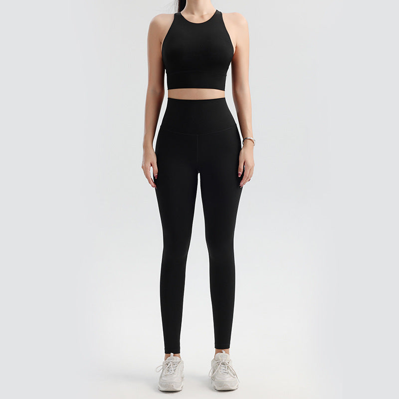 Person wearing a black athletic outfit on a white background