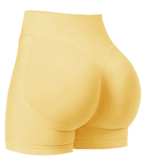Yellow athletic shorts on a white background