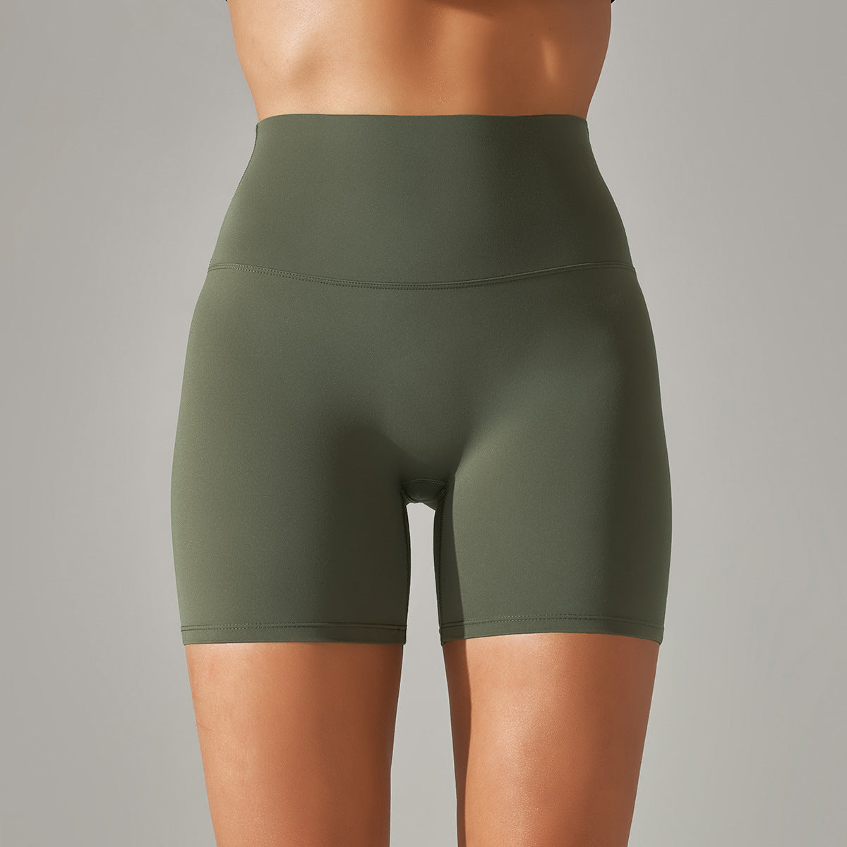 Green athletic shorts worn by a person on a gray background