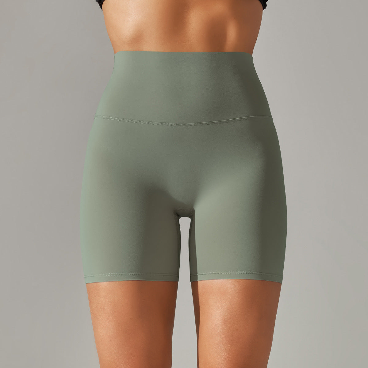 Green athletic shorts worn by a person on a gray background