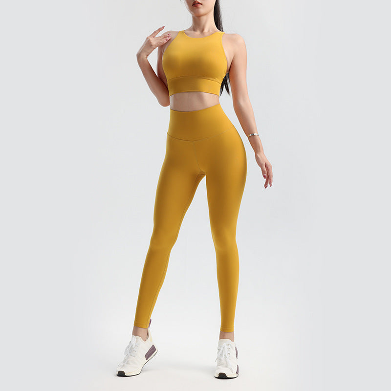 Person wearing a mustard yellow athletic outfit on a white background