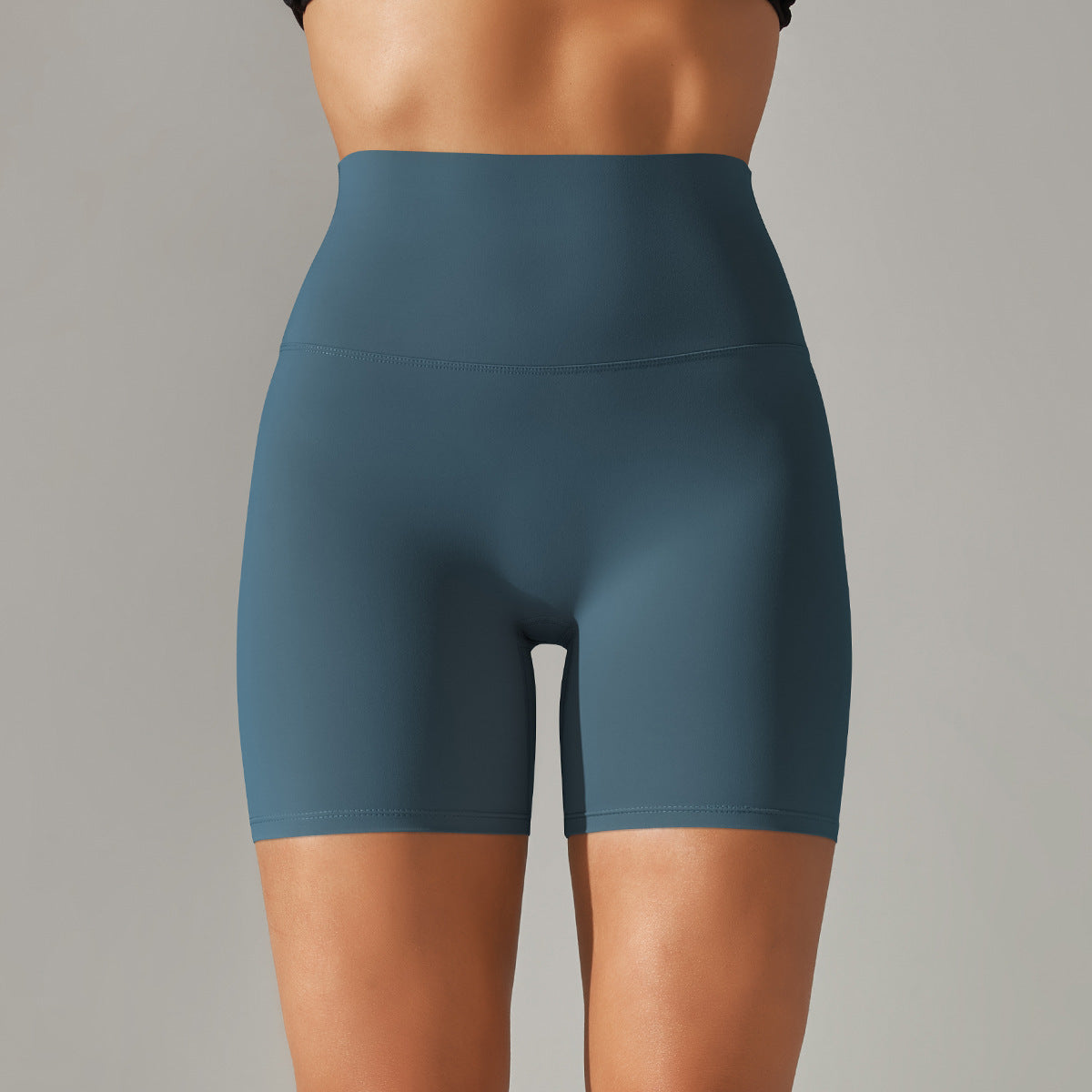 Blue athletic shorts worn by a person on a gray background