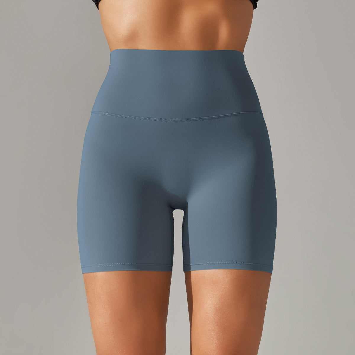 Blue athletic shorts worn by a person on a gray background