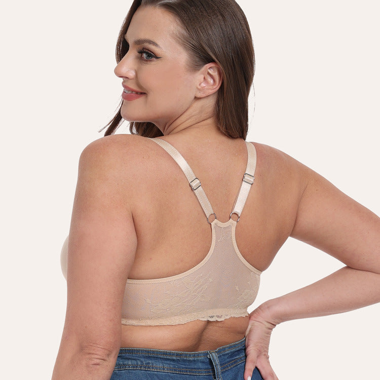 Woman wearing a beige bralette on a plain background