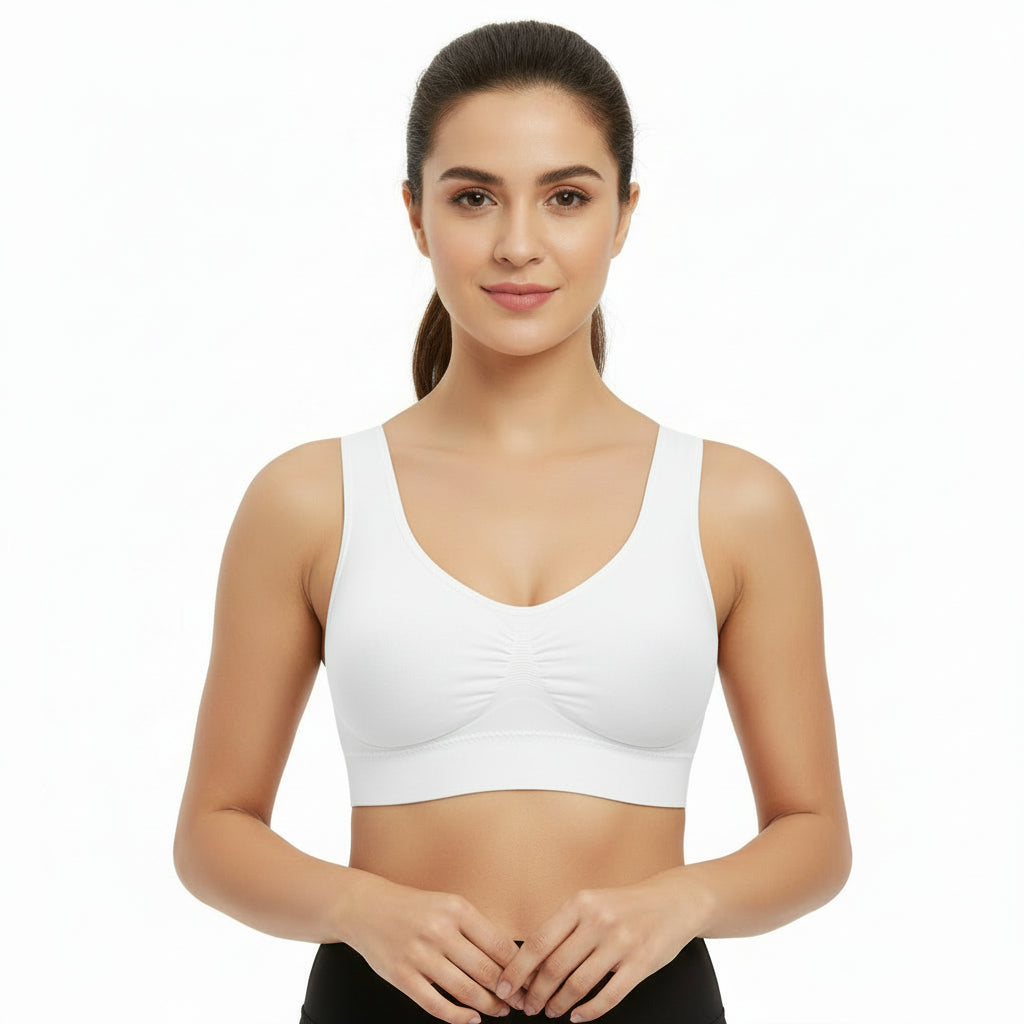 Woman wearing a white sports bra on a white background