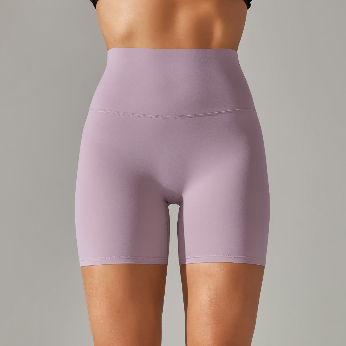 Purple athletic shorts worn by a person on a gray background