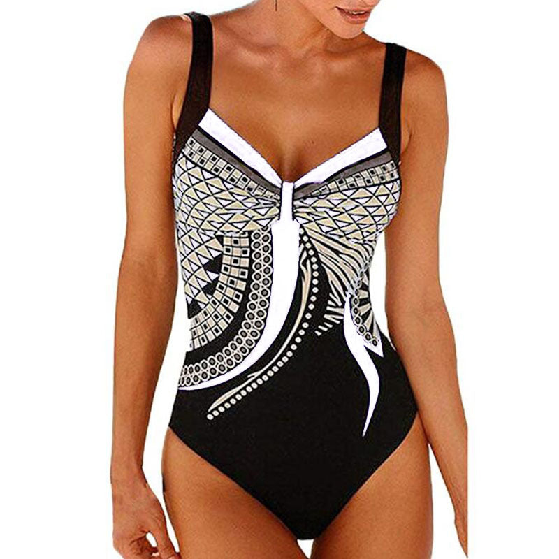 Black and white patterned swimsuit on a model against a white background