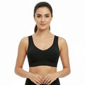 Woman wearing a black sports bra on a white background