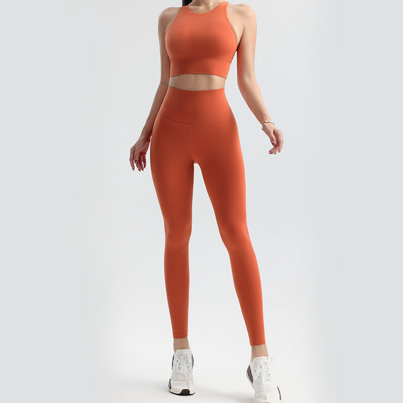 Person wearing an orange athletic outfit on a white background