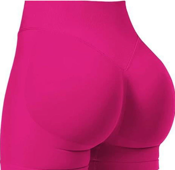 Close-up of bright pink shorts on a white background