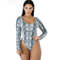 Woman wearing a snake print long-sleeve swimsuit on a white background