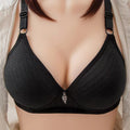 Black bra with a decorative clasp on a neutral background