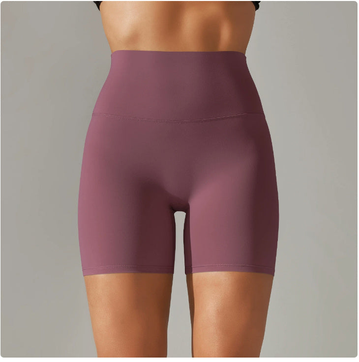Purple athletic shorts worn by a person on a gray background