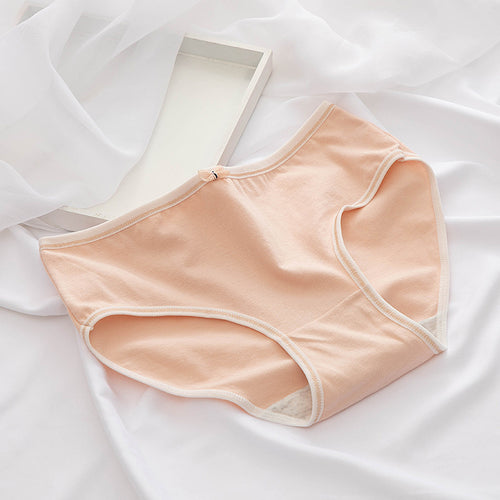 Light pink underwear on a white fabric background