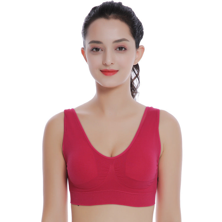 Woman wearing a red bralette on a white background