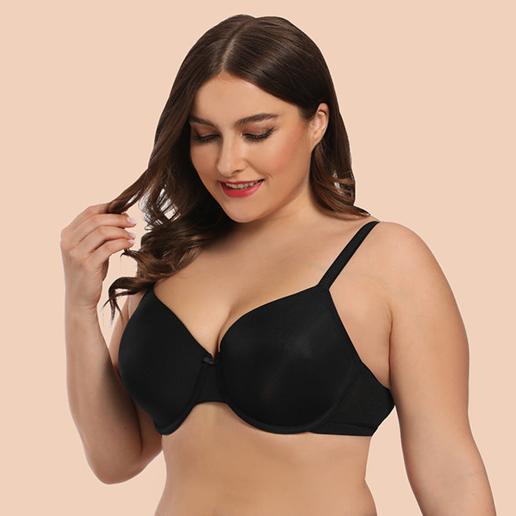 Woman wearing a black bra against a beige background