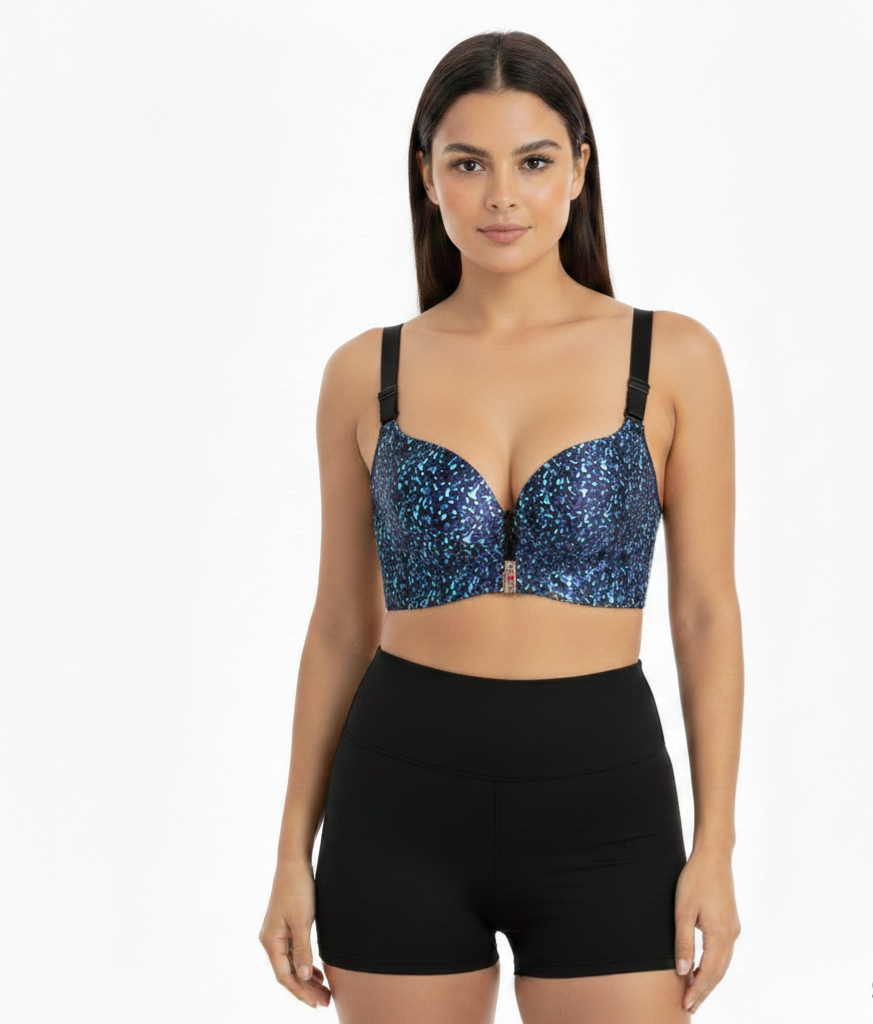 Woman wearing a blue sequin bralette and black high-waisted shorts on a white background