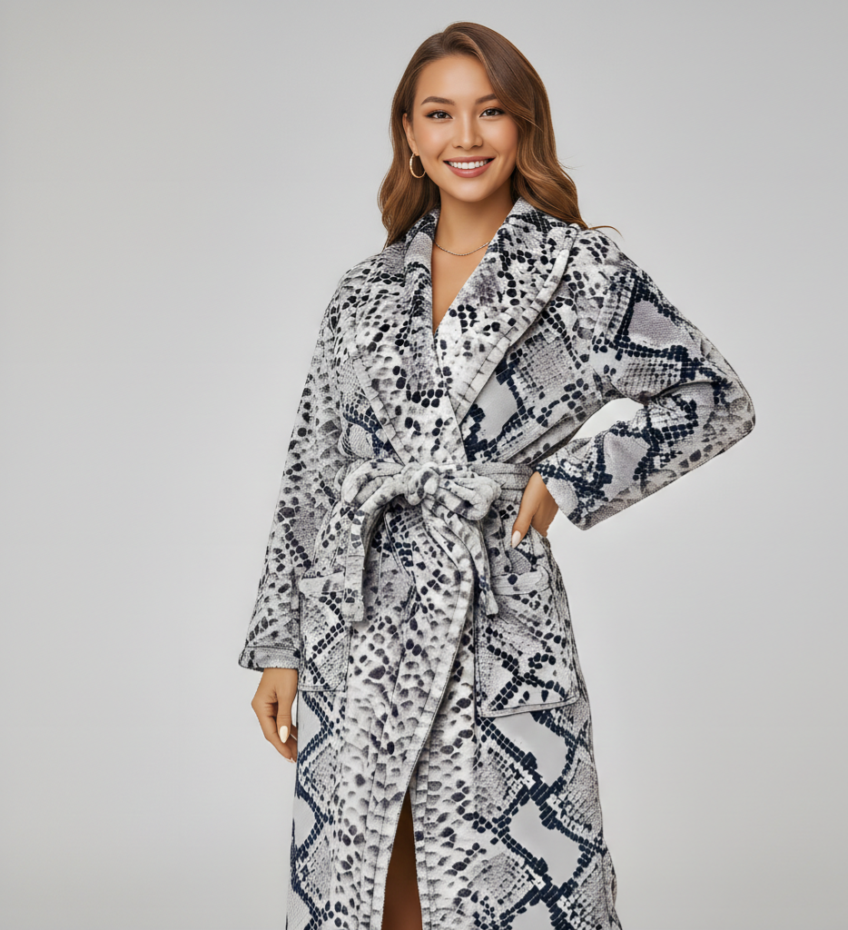 Woman wearing a patterned robe against a plain background