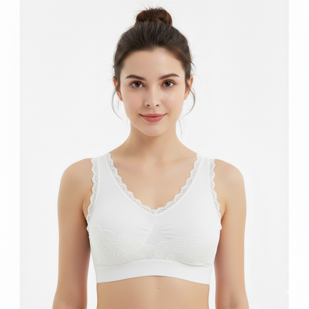 Woman wearing a white lace-trimmed top against a plain background