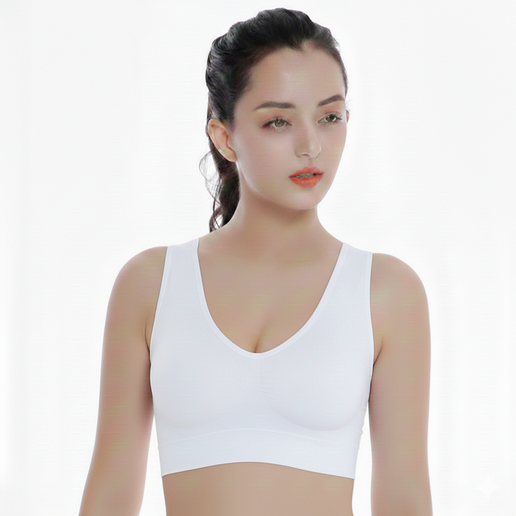 Woman wearing a white tank top against a plain background