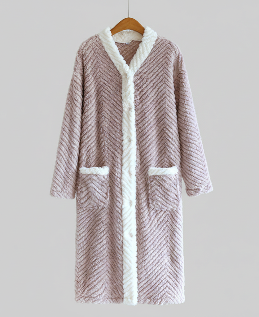 Fluffy pink robe with white trim on a hanger against a light gray background