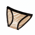 Beige underwear with black lace trim on a white background