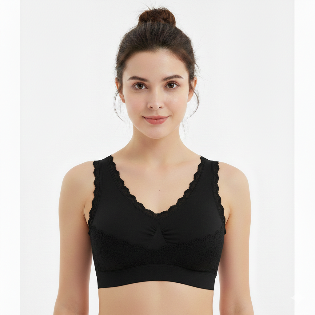 Woman wearing a black lace-trimmed bralette on a white background