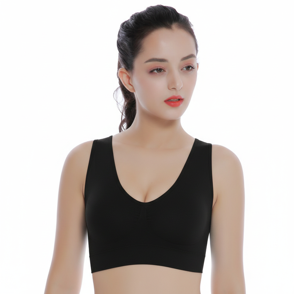 Woman wearing a black sports bra on a white background